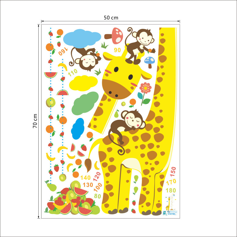 Child standing against a baby height chart wall sticker